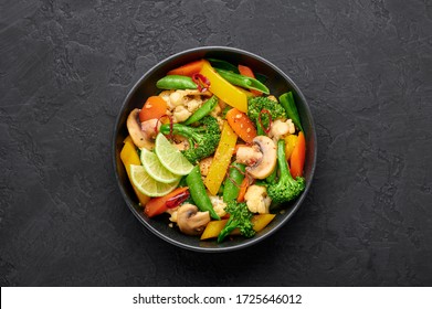 Pad Pak Ruam Or Veg Thai Stir-Fried Vegetables In Black Bowl On Dark Slate Backdrop. Pad Pak Is Thailand Cuisine Vegetarian Dish With Mix Of Vegetables And Sauces. Thai Food. Top View