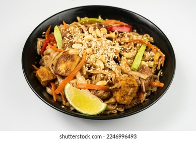 Pad thai. vegetarian dish in black dishes on a white background. a Thai dish. - Shutterstock ID 2246996493
