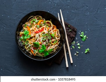 Pad Thai vegetarian vegetables udon noodles in a dark background, top view. Vegetarian food in asian style. Copy space  - Shutterstock ID 1037818495