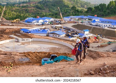 Padang, Indonesia - October 27, 2020: Two Workers Are Walking Past A Construction Site For A Government Building.