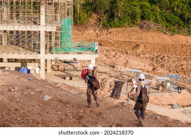 Padang, Indonesia - October 27, 2020: Two Workers Are Walking Past A Construction Site For A Government Building.