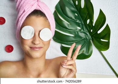 padded disks in front of a woman, peeling, skin care, cosmetic procedures
