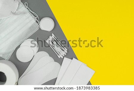 Сotton pad.dental floss, masks, toilet paper on a gray background.Trending colors 2021