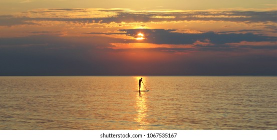 paddle board sunset