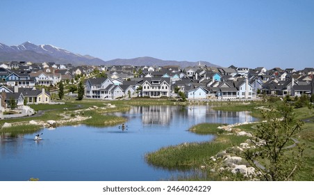 Paddle Boarders and Canoers Adventuring Through Oquirrh Lake in Daybreak South Jordan Utah  - Powered by Shutterstock