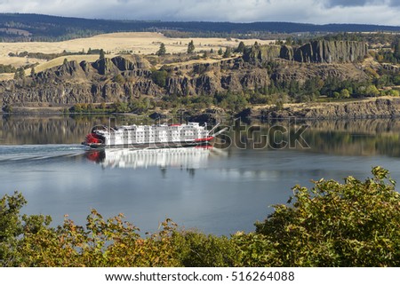 Paddle boat cruising up the Columbia River in the Columbia River Gorge which separates Oregon from Washington.