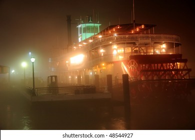 A Paddle Boat Moored On Very Foggy Banks Of The Mississippi River In New Orleans, LA