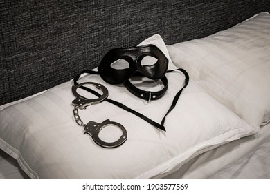 Paddle, Collar And Mask On Pillow. Domestic Discipline. Traditional Corporal Punishment Implements. BDSM