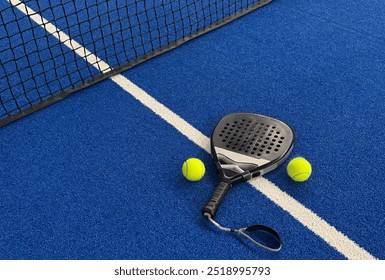 Paddle racket with a ball ready to play the fastest growing sport in recent years worldwide. Padel court in summer, the perfect time to practice this sporting discipline and release stress. - Powered by Shutterstock