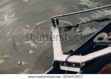 Paddle rowlock of rowing boat at water surface