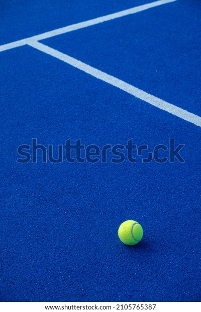 Paddle tennis ball on a blue paddle tennis court.\
Racket sports