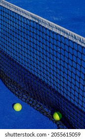 Paddle Tennis. Detail Of The Net Of A Blue Paddle Tennis Court And Two Balls.