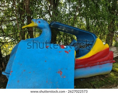 Paddle wheeler, Duck pedal boat, old and abandoned, not maintained and not fit for use. Blue color, angle 1