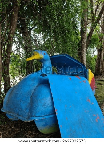 Paddle wheeler, Duck pedal boat, old and abandoned, not maintained and not fit for use. Blue color, angle 2