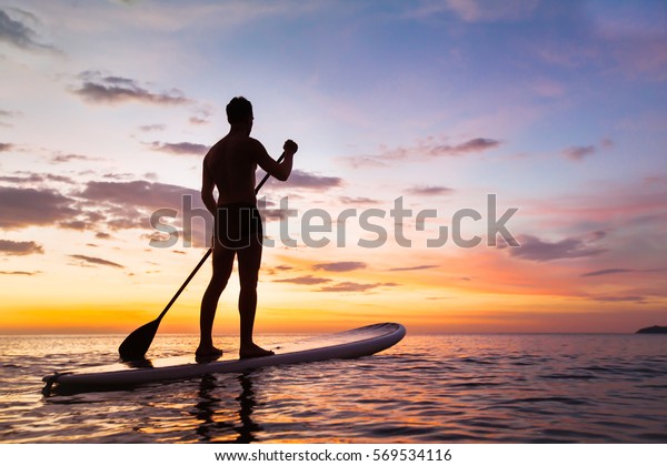 Paddleboard On Beach Sunset Paddle Standing Stock Photo 569534116 