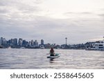 Paddleboarder on Calm Waters with Seattle Skyline