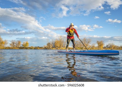 Paddling Stand Up Paddleboard On A Lake In Colorado, Fall Scenery With A Copy Space