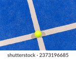 padel ball on a padel blue court 