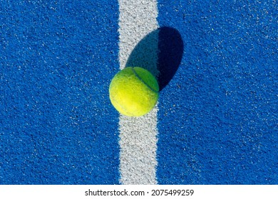 Padel Ball On A Blue Court