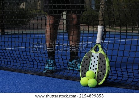 Padel is a racket sport and typically played in doubles on an enclosed court roughly 25% smaller than the size of a tennis court.