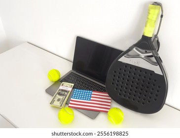 padel racket and yellow balls, laptop