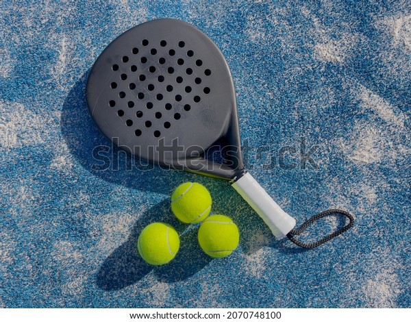 padel tennis racket\
sport court and balls\
