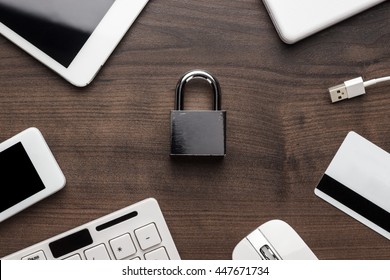 padlock and different gadgets on the wooden office table. privacy protection, encrypted connection concept, buying online