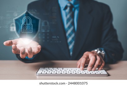 padlock, firewall, defense, network, system, software, protect, encryption, tech, safety. A man is typing a keyboard and hold a blue padlock middle of shield virtual screen with a blue background.