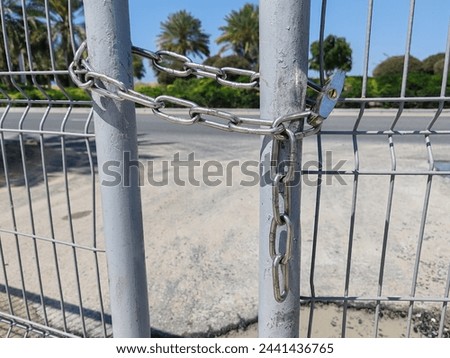 Padlock, Lock on fence. Padlock on gate, metal lock on chain to protect the property for unauthorized access. Locked out the main fence door with chain lock for no entry. 