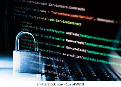 Padlock on laptop with a programming language. Internet data privacy information security concept. Antivirus and malware defense.