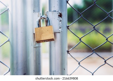 Padlock On Metal Cage Door (security Business Concept)