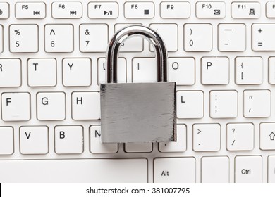 padlock and white computer keyboard on the wooden office table. privacy protection, encrypted connection concept
