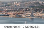 Padrao dos Descobrimentos or Monument to the Discoveries aerial timelapse located on the waterfront on northern bank of the Tagus River in Lisbon, Portugal. City panorama with typical houses