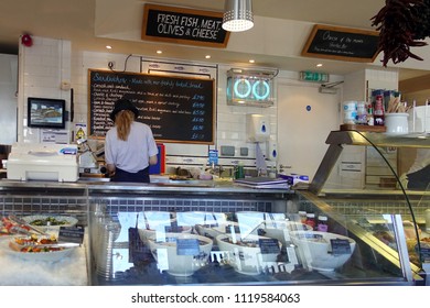 Padstow, Cornwall, April 11th 2018: Woman Preparing Food In A Seafood Speciality Delicatessen