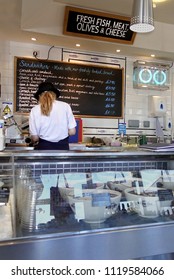 Padstow, Cornwall, April 11th 2018: Woman Preparing Food In A Seafood Speciality Delicatessen