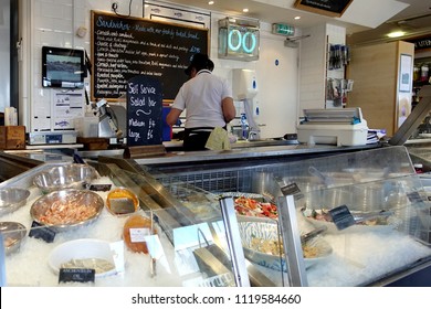 Padstow, Cornwall, April 11th 2018: Woman Preparing Food In A Seafood Speciality Delicatessen