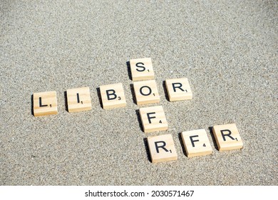 Padua, Italy - 24 August 2021: LIBOR, SOFR And RFR Written In Sand, As A Concept For The Transition From London Interbank Offered Rate To A Risk-free Rate Such As Secured Overnight Financing Rate