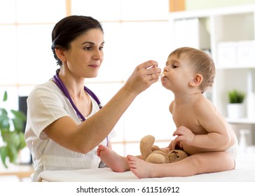 Paediatrician Doctor Giving Medicament With A Spoon.