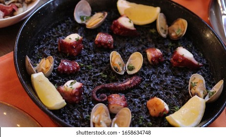 Paella Black Ink, Octopus And Clams. 