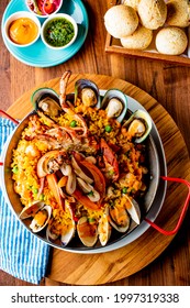 Paella. Traditional classic Spanish seafood dish with fresh seafood, shrimp, mussels, clams, squid cooked in fish broth with saffron and rice garnished with cilantro. 