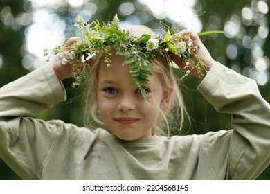 Pagan Ritual, Close-up Portrait Of A Child Girl With A Wreath In The Forest.