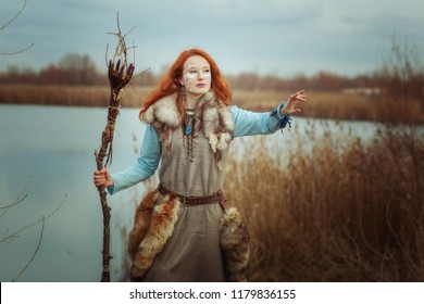 Pagan Woman Is A Shaman With A Staff In Her Hands.