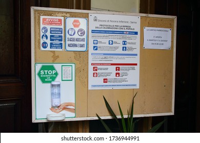 Pagani,Sa,Italy - May 19,2020 : A Notice Board Placed At The Entrance Of The Church With Notices On Safety Rules To Be Observed Before Entering . Hand Sanitizer, Mask, Gloves And Norms Of Distance .