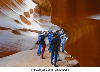 PAGE, AZ - MAY 26: Upper Antelope Canyon Tour On May 26, 2015 In Page AZ,USA. Thousands Of People From All Over The World Come To Visit Upper Antelope Canyon