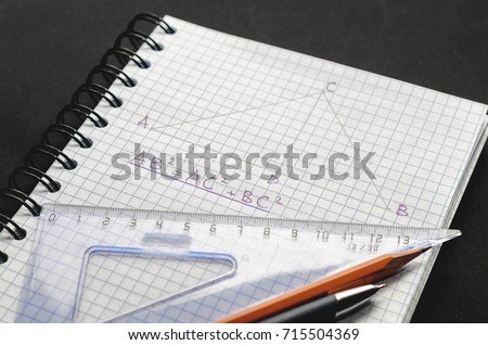 Page with formulas and the Pythagorean theorem with pen, pencil and ruler