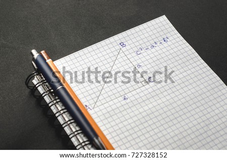 Page with formulas and the Pythagorean theorem with pen and pencil