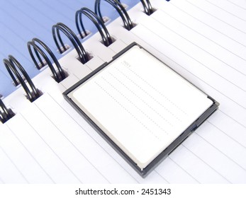 Page of a notebook with compactflash for storage of the information on the camera.  COPYSPACE - a place for accommodation of advertising in a photo.