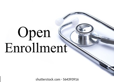 Page with Open Enrollment on the table with stethoscope, medical concept.