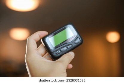 pager beeper lies on a desk, symbolizing instant communication and connection, bridging distances and enabling efficient messaging in the digital age