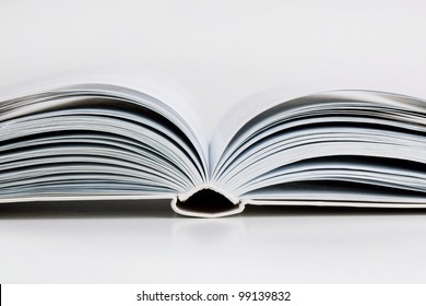 Pages open a thick book on white background